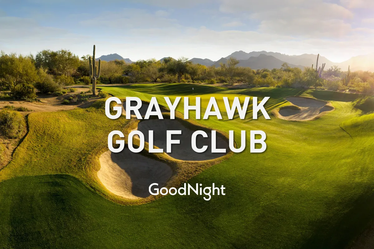This image presents a scenic golf course framed by sand traps, cacti, and mountains in the background. The setting is tranquil and ideal for outdoor recreation, capturing the essence of North Scottsdale's world-class golf offerings.