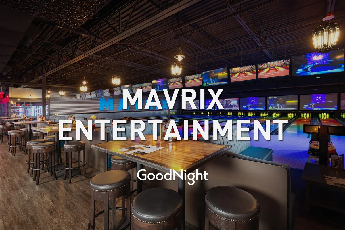 A vibrant entertainment venue with bowling lanes, a lively bar area, and multiple screens displaying sports games. The atmosphere is energetic and playful, with plenty of seating and activity for guests of all ages.